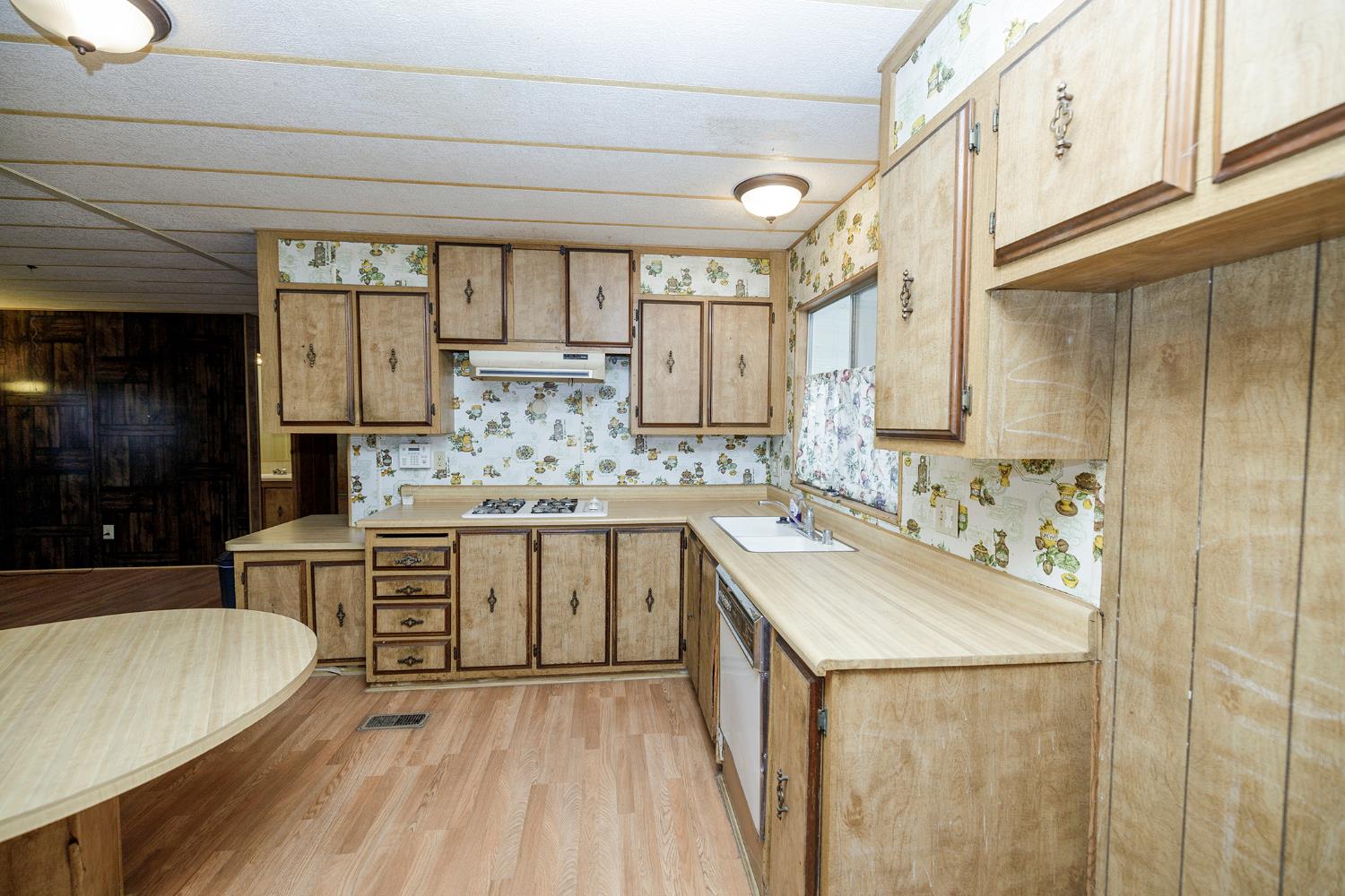 2621 Prescott Road, Unit 158 Modesto, CA 95350 - Photo 17 of 35 a kitchen with kitchen island white cabinets and appliances