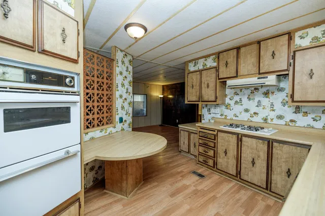 a kitchen with stainless steel appliances a stove a sink dishwasher and cabinets