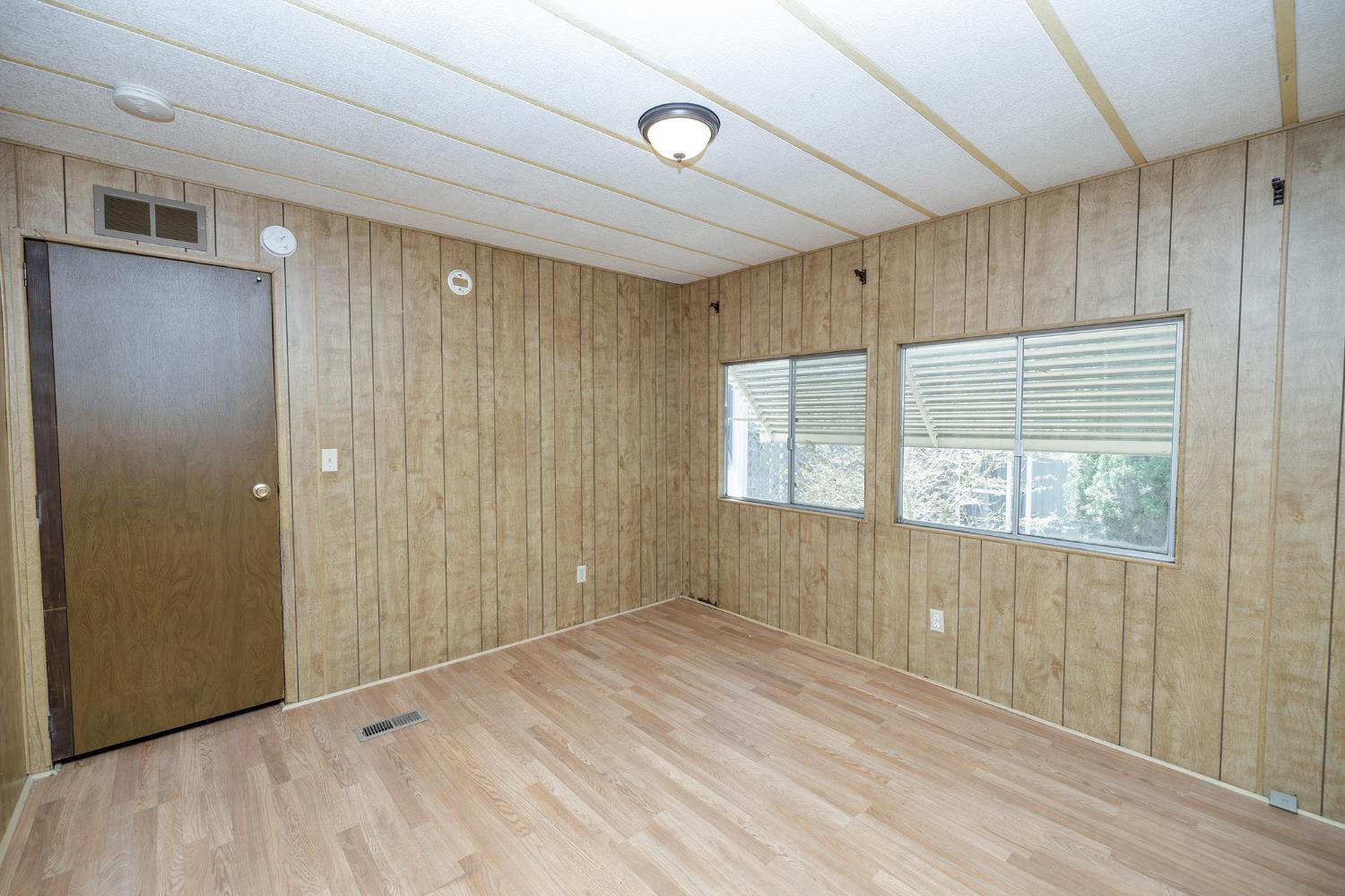 2621 Prescott Road, Unit 158 Modesto, CA 95350 - Photo 26 of 35 a view of an empty room with wooden floor and a window