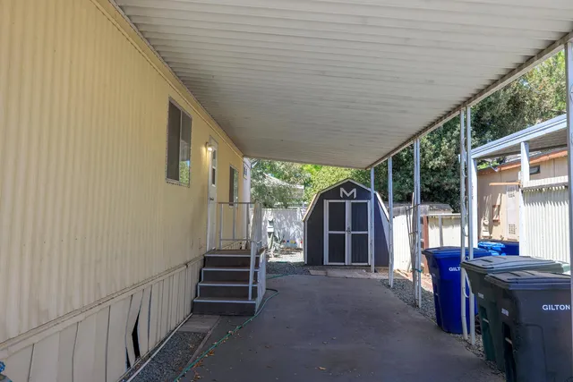a view of a house with backyard and porch