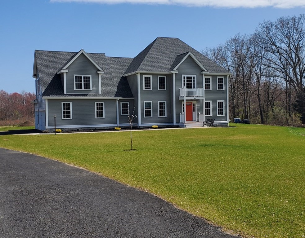 a front view of a house with swimming pool and garden