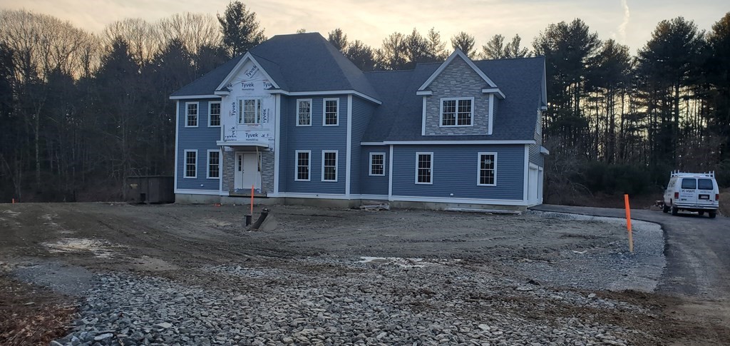 48 Lackey Street Westborough, MA 01581 - Photo 2 of 2 a view of a big house with a yard and large trees