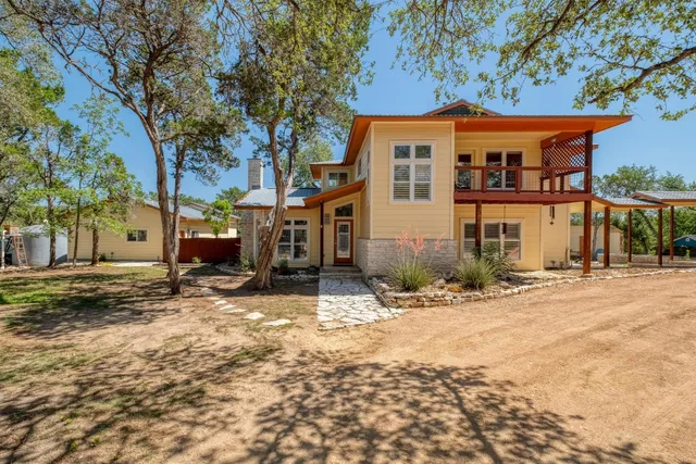 a backyard of a house with yard and tree