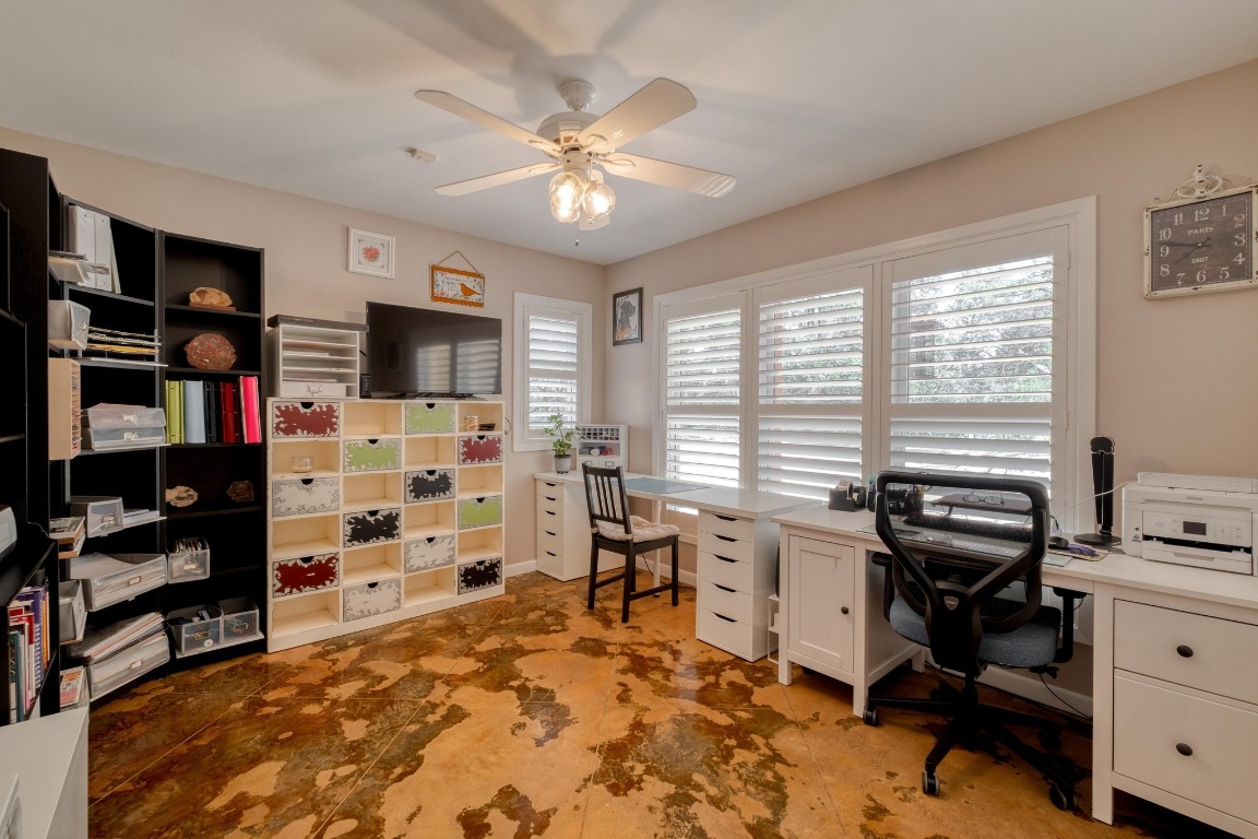 7600 Deer Run Road Leander, TX 78641 - Photo 12 of 39 a view of a workspace with furniture and a window