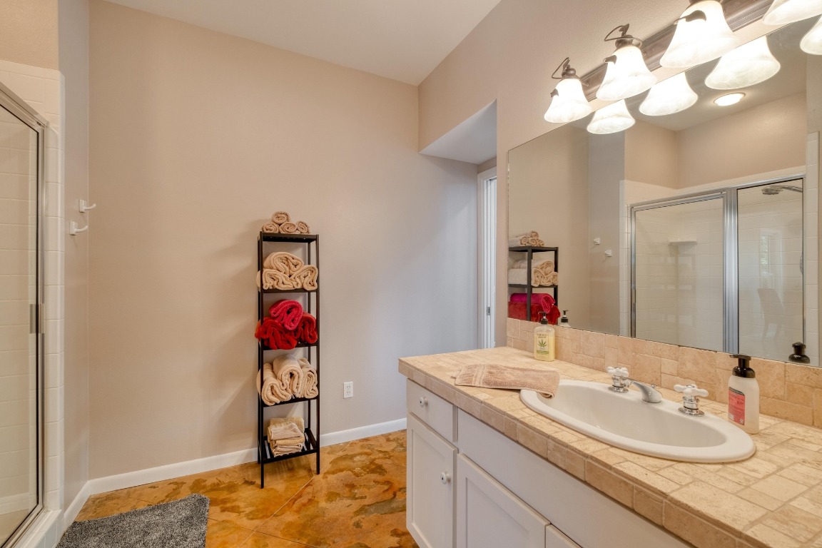 7600 Deer Run Road Leander, TX 78641 - Photo 13 of 39 a bathroom with a sink vanity and a mirror
