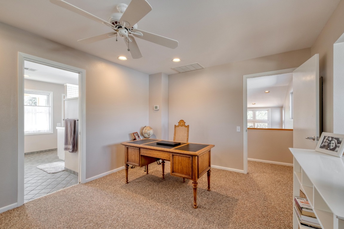 7600 Deer Run Road Leander, TX 78641 - Photo 15 of 39 a view of a workspace with furniture and a bathroom