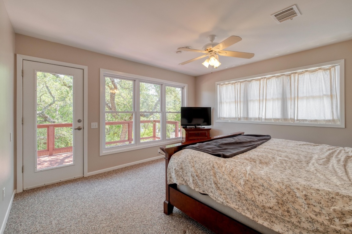 7600 Deer Run Road Leander, TX 78641 - Photo 16 of 39 a bedroom with a large bed and a large window