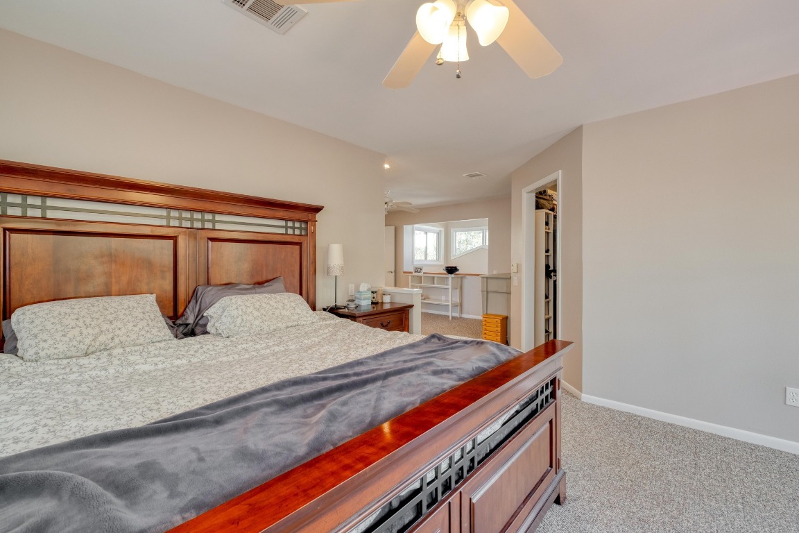 7600 Deer Run Road Leander, TX 78641 - Photo 17 of 39 a bedroom with a bed and a mirror