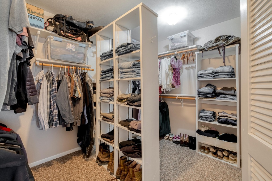 7600 Deer Run Road Leander, TX 78641 - Photo 18 of 39 a view of walk in closet with clothes and shoes