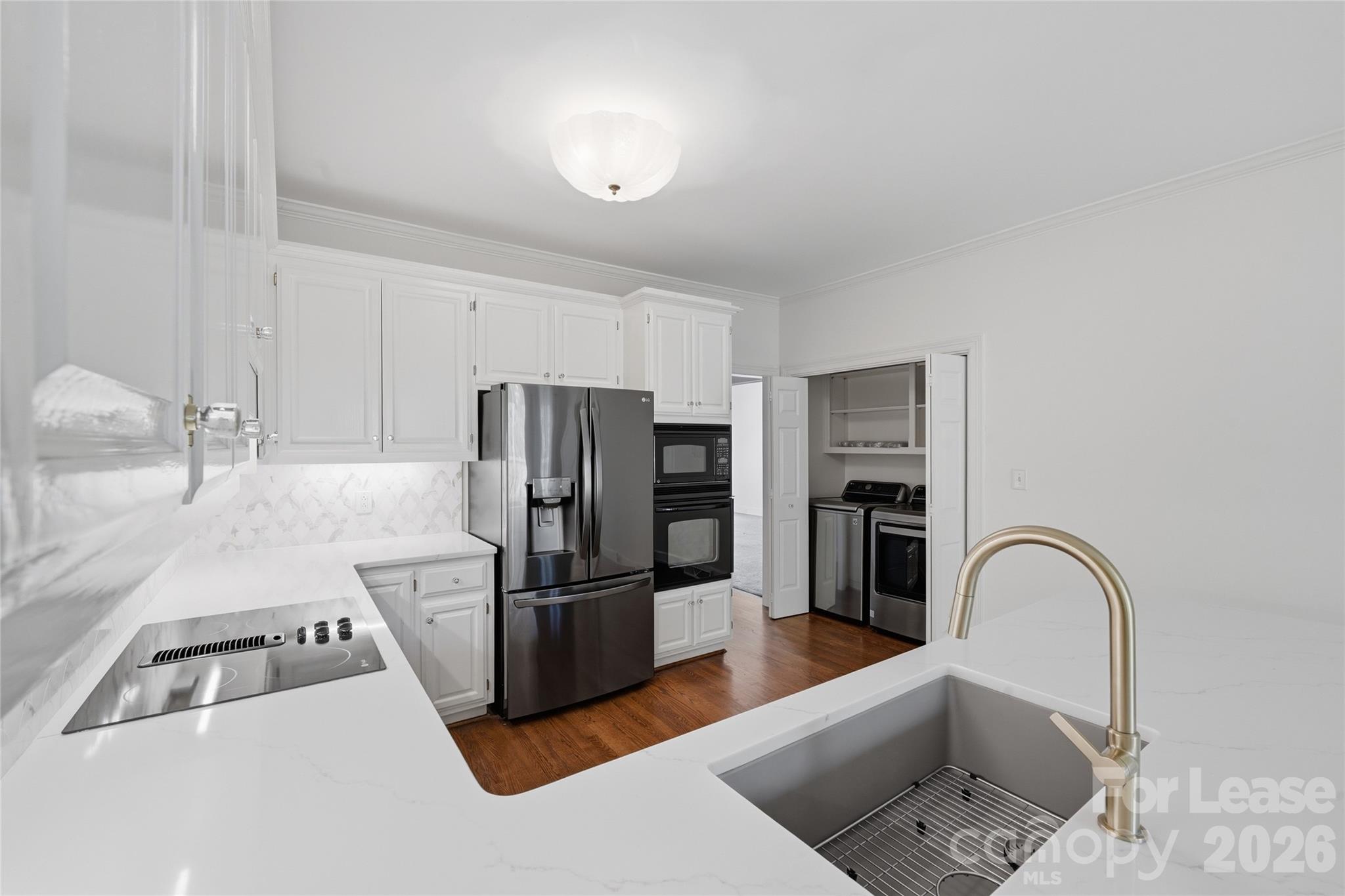 5906 Sharon Hills Road Charlotte, NC 28210 - Photo 16 of 30 a kitchen with stainless steel appliances kitchen island a refrigerator and a stove top oven