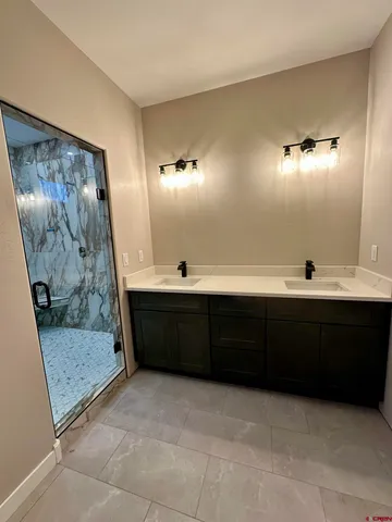 a bathroom with a double vanity sink and a mirror
