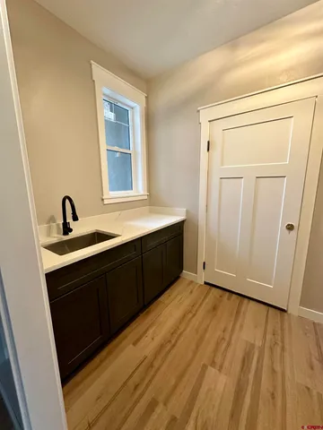 a bathroom with a sink a mirror and a window