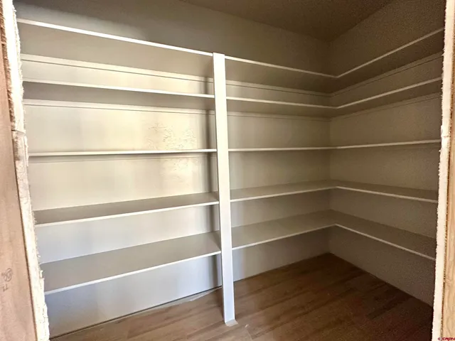 a view of walk in closet with empty racks