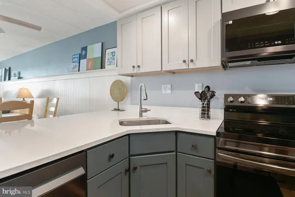 a kitchen with stainless steel appliances granite countertop a refrigerator sink and stove