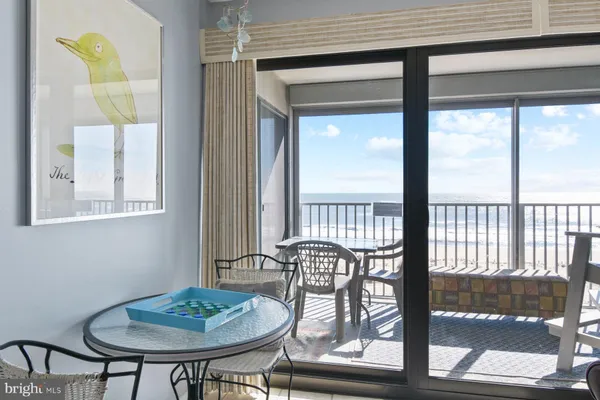 a dining room with furniture and a window