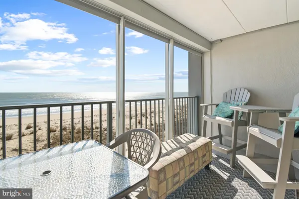 a view of a dining room with furniture and a large window