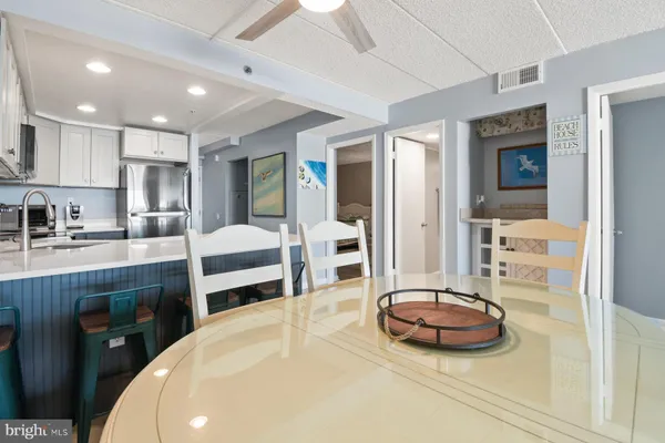 a kitchen with stainless steel appliances granite countertop a refrigerator stove top oven and sink