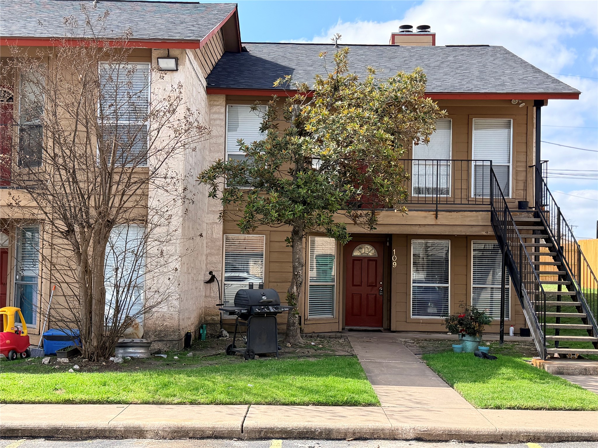209 East Noton Street, Unit 109 Pflugerville, TX 78660 - Photo 1 of 11 a front view of a house with garden