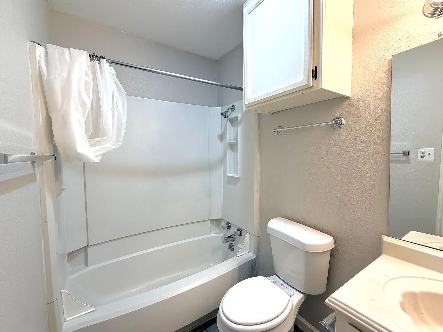 209 East Noton Street, Unit 109 Pflugerville, TX 78660 - Photo 11 of 11 a white toilet sitting next to a bath tub shower