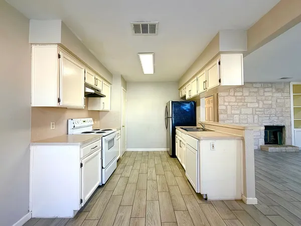 a kitchen with a sink stove and cabinets