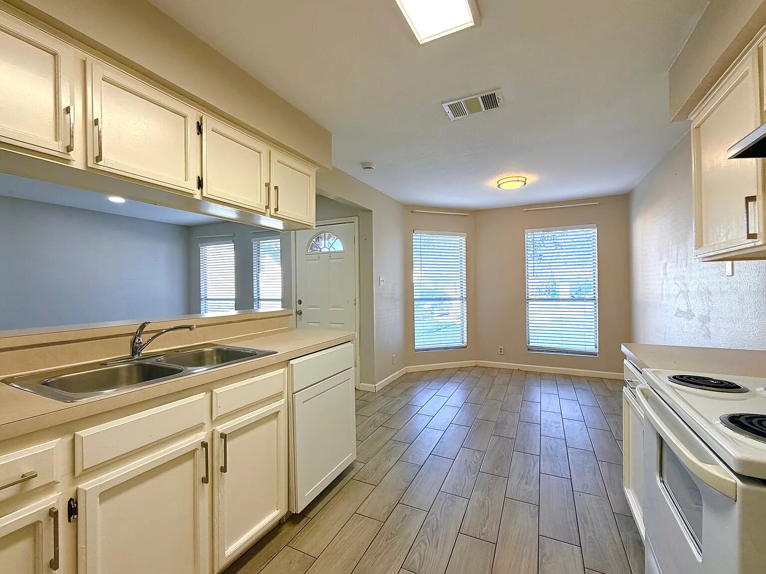 209 East Noton Street, Unit 109 Pflugerville, TX 78660 - Photo 6 of 11 a kitchen with a sink stove and cabinets