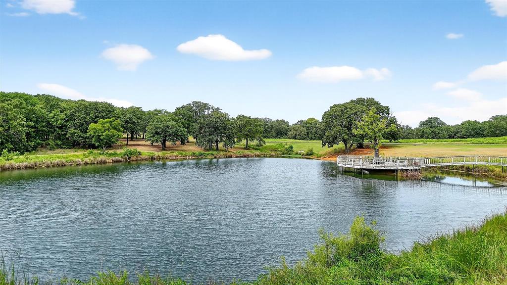 2887 Liberty Road Gordonville, TX 76245 - Photo 18 of 40 a view of a lake with a yard and trees
