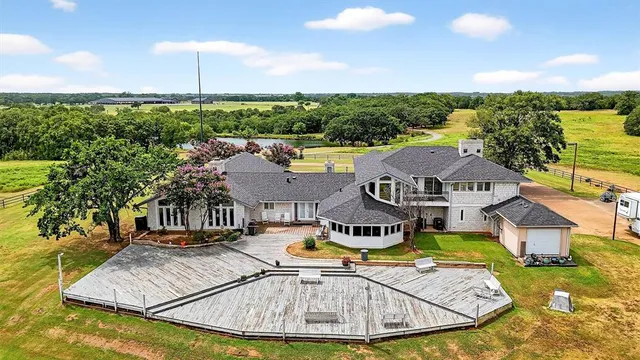 a front view of a house with swimming pool having outdoor seating