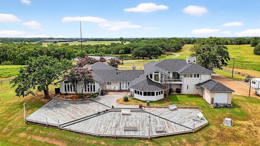 2887 Liberty Road Gordonville, TX 76245 - Photo 22 of 40 an aerial view of a house with a big yard and palm trees