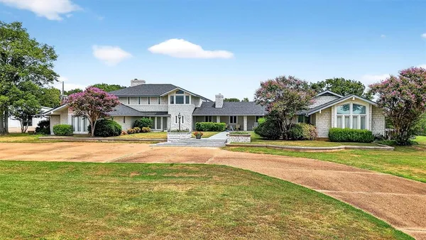a house with swimming pool in front of it
