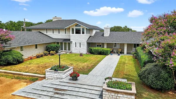 a view of a house with pool and chairs