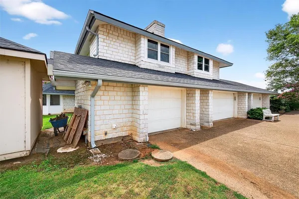 a view of swimming pool with lawn chairs and plants