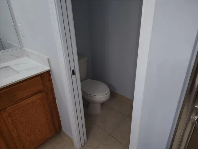 a white toilet sitting next to a sink