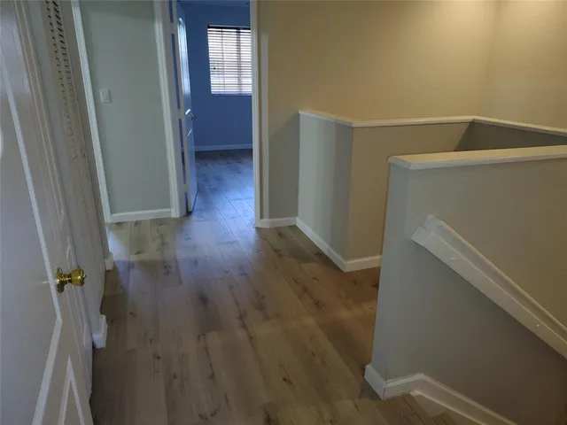 a view of hallway with wooden floor