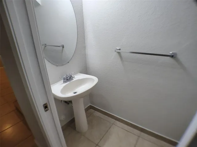 a bathroom with a sink a mirror and shower