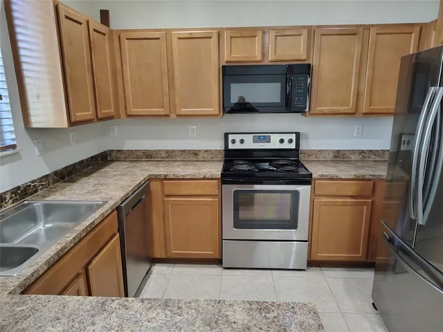 a kitchen with a sink stove and microwave
