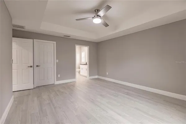 a view of an empty room with a ceiling fan
