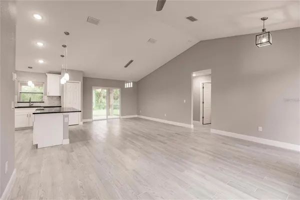 a view of kitchen with sink and natural light