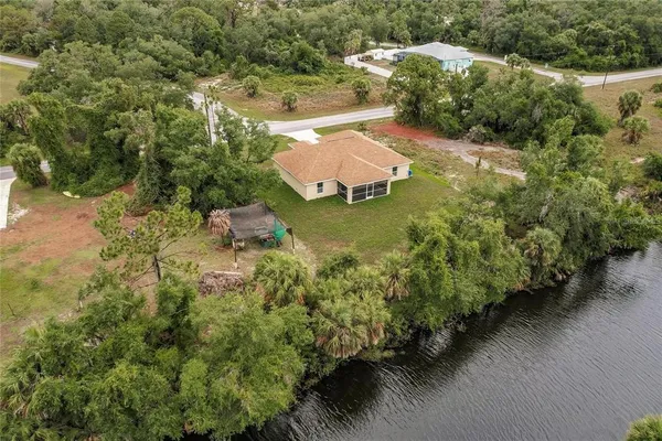 an aerial view of a house with a yard