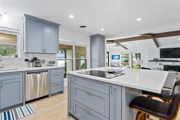 a kitchen with a sink cabinets and window