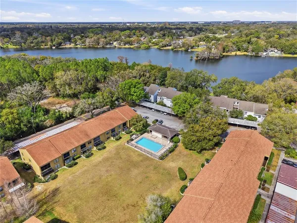 an aerial view of residential houses with outdoor space and river