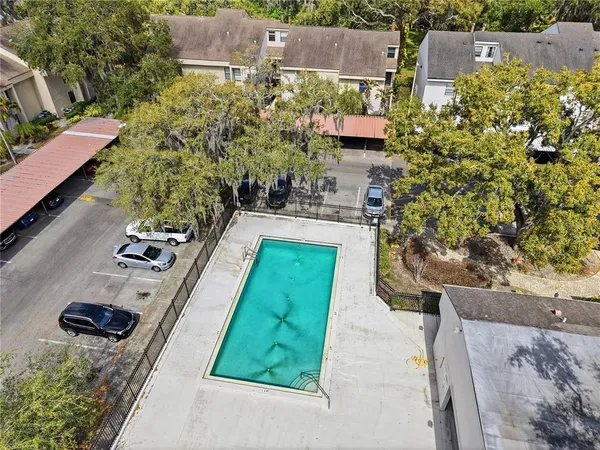 an aerial view of a house with a yard