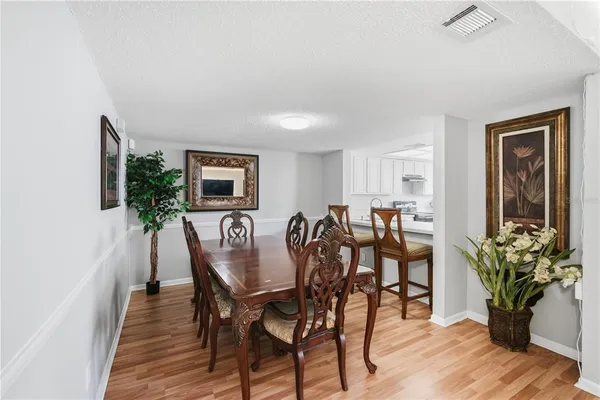 a dining room with furniture and wooden floor