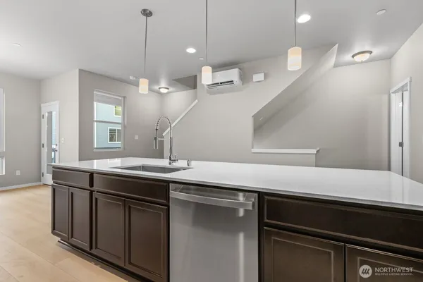 a kitchen with stainless steel appliances granite countertop a stove and a sink