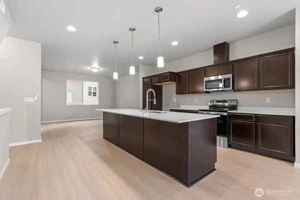 a view of wooden floor and a chandelier in a room