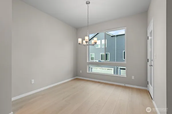a view of a room with a chandelier fan and windows