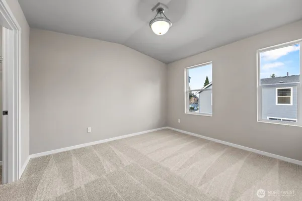 an empty room with cabinet and mirror
