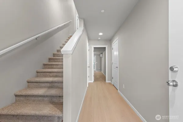 a view of a hallway with wooden floor