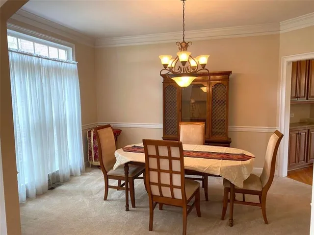 a bathroom with a tub a sink and a large mirror