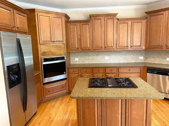 a kitchen with a stove and a chandelier