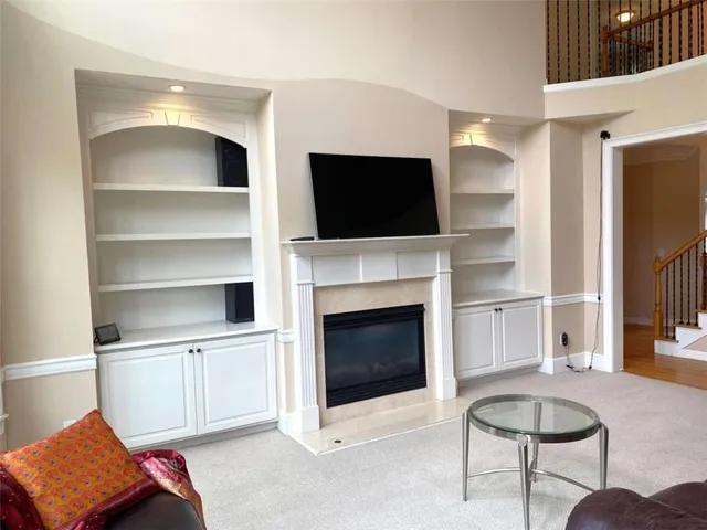 an empty room with a window and doors